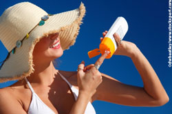 Woman applying sun cream