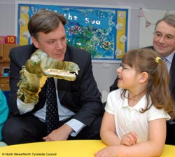 Ed Balls, with glove puppet , interacts with pupils