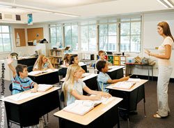 Classroom of students being helped by teacher