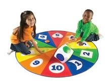 children on number wheel play mat with dice