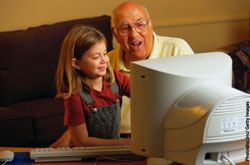 Child helping grandparent to use a computer Child helping grandparent to use a computer