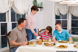 Family seated at the table enjoying a meal