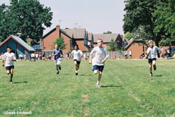 Childern running a race on school field