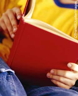 close up of childs hands holding book close up of childs hands holding book