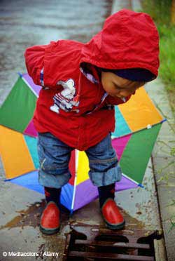 child playing in the rain