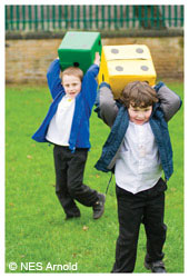 Boys playing with large dice